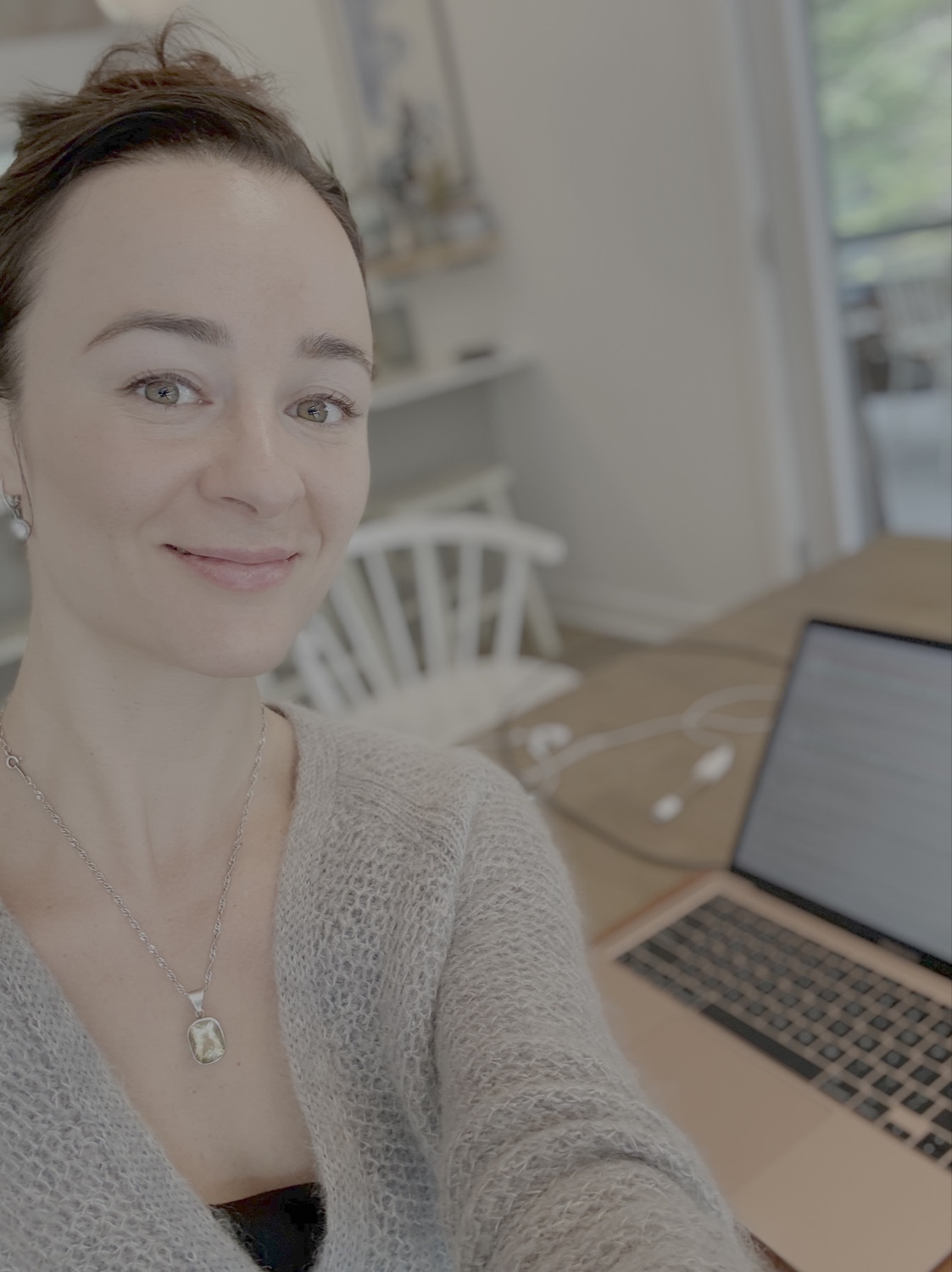 Olivia, founder of Vinvely, designing at her laptop